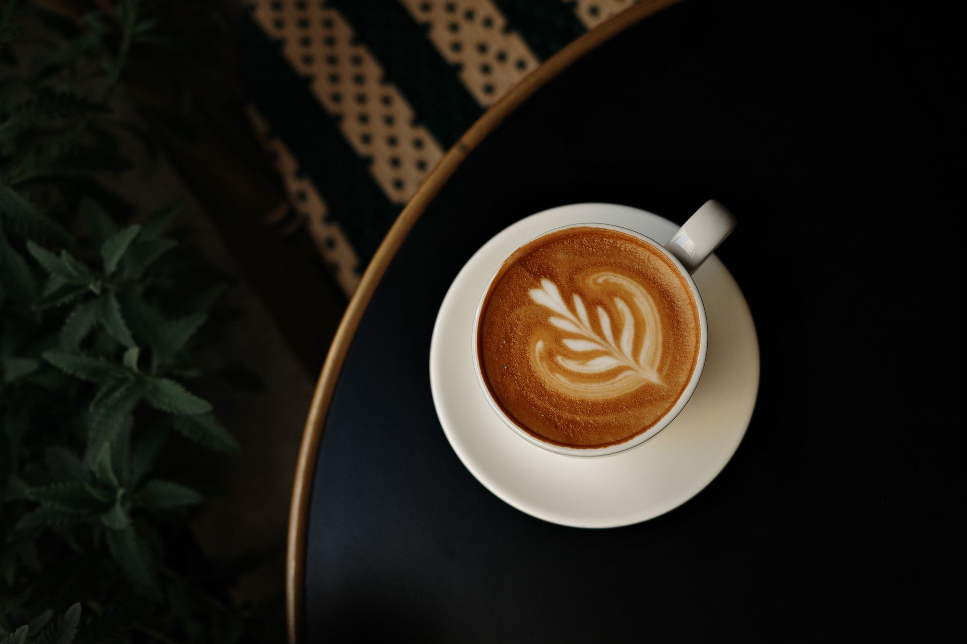 Stunning Ethiopian double espresso latte art prepared on wood barista table